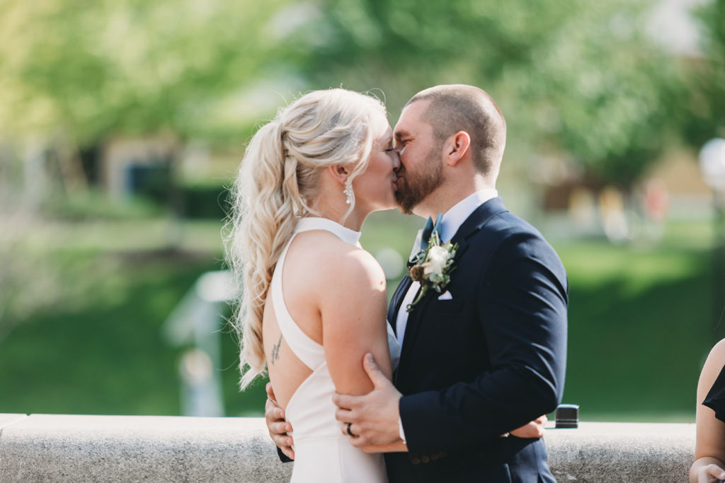bride and groom share first kiss at their indy canal wedding