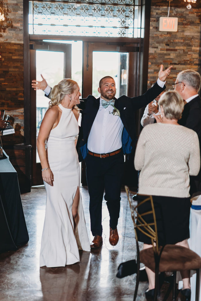 bride and groom enter reception at an indy canal wedding