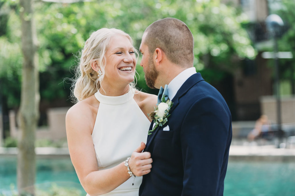 bride smiles and laughs with groom at her indy canal wedding