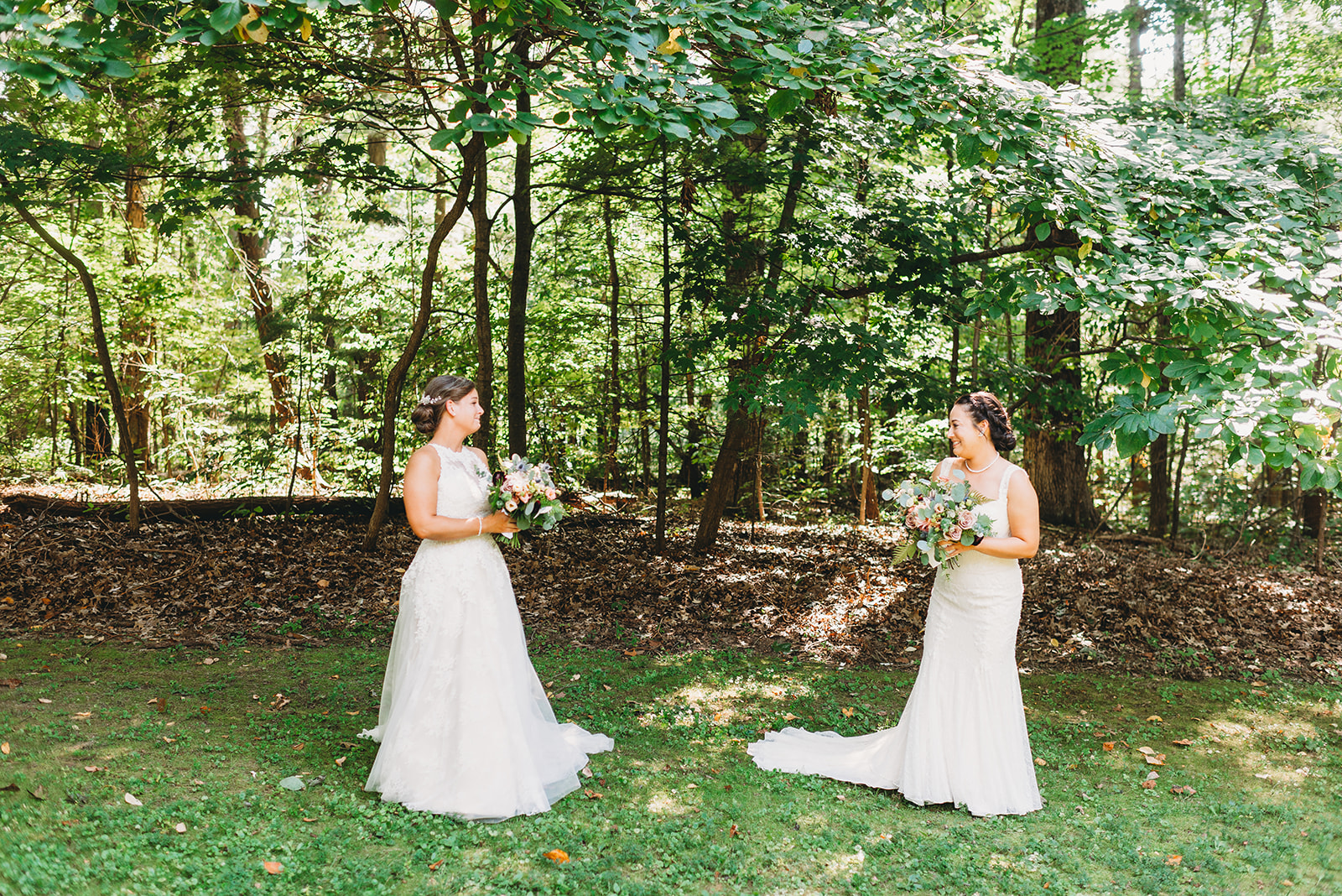 two brides share a first look and smile at each other during a Martinsville wedding