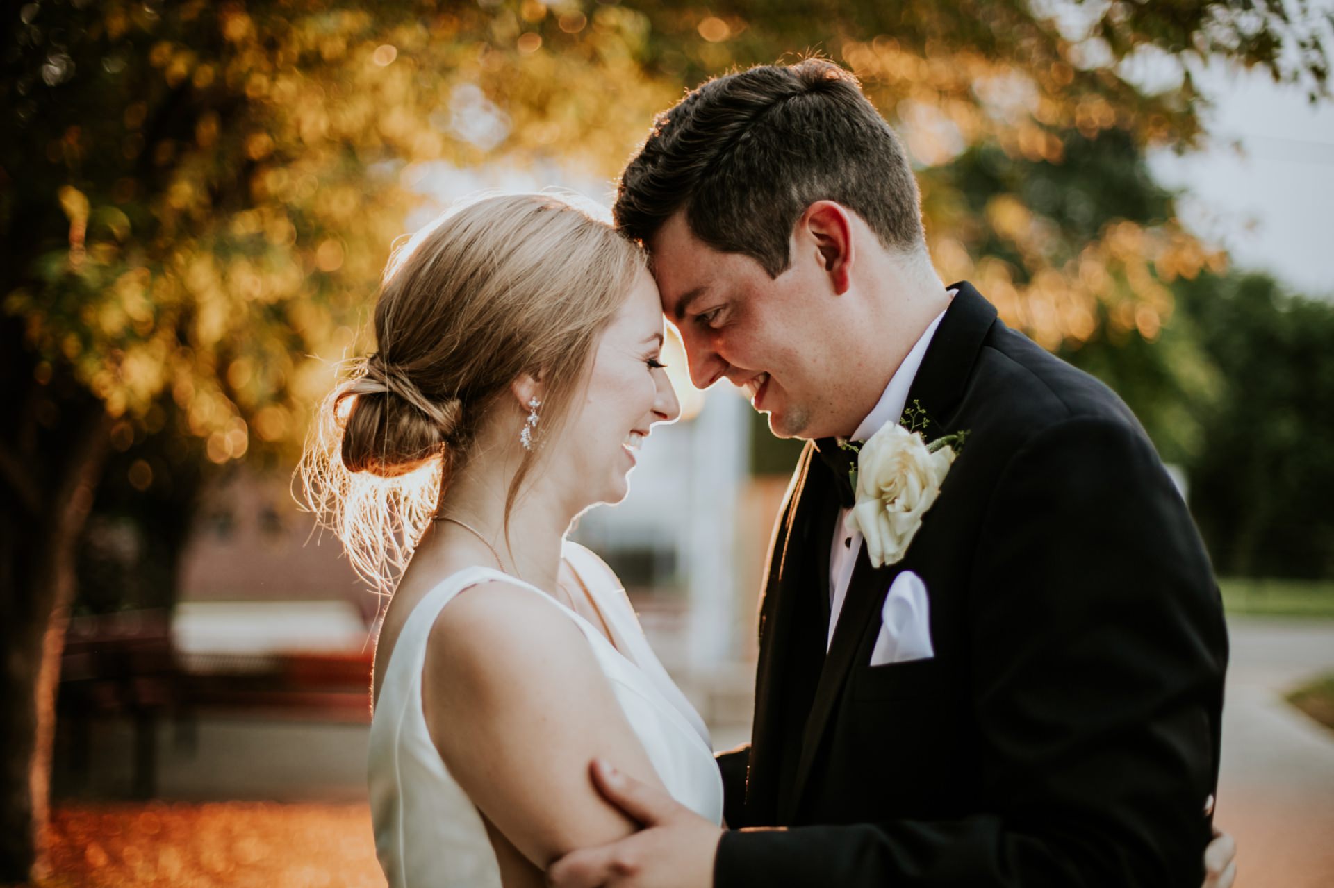bride and groom touch their foreheads together at sunset during their Tinker House Wedding