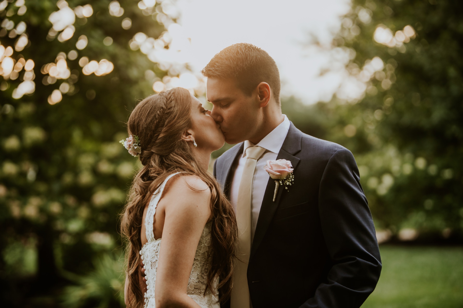 bride and groom kiss at sunset at mustard seed gardens with orange tones for Noblesville Wedding Photography