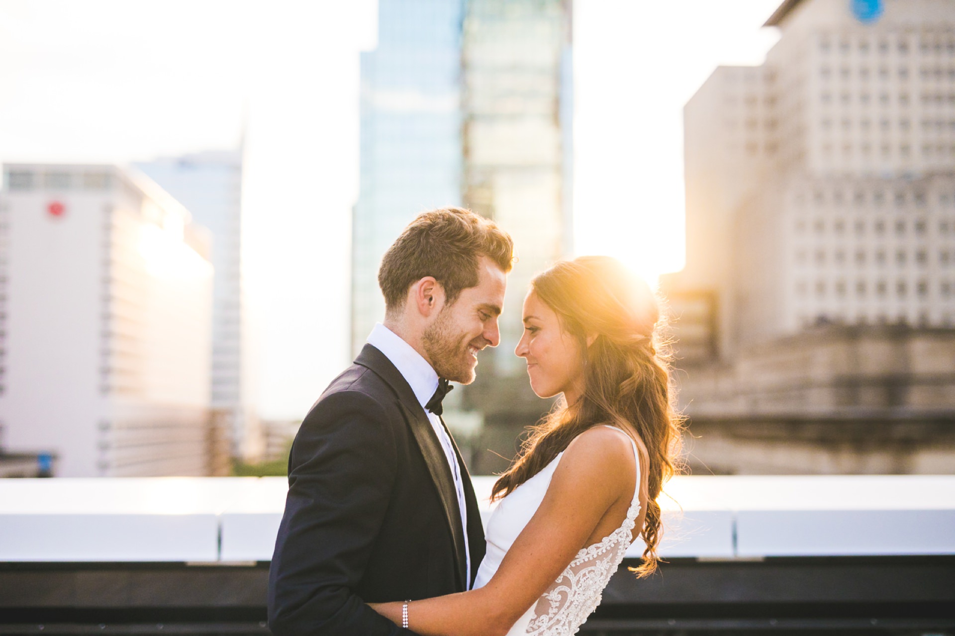 bride and groom hug and laugh at sunset in Indianpaolis for Regions Tower wedding photography