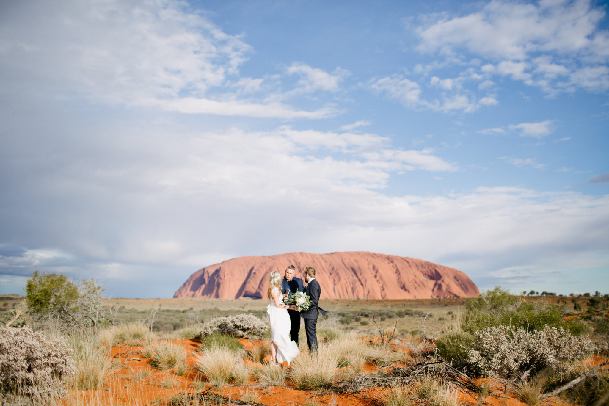 Josh Withers, Australian Wedding Celebrant and podcast guest, officiates a wedding in Australia in front of brown mountains