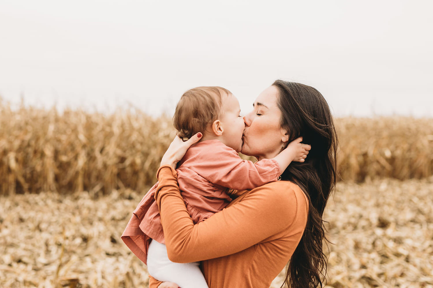mom kisses her baby during this Central Indiana Family Photography session
