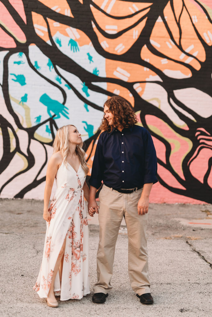 woman and man in front of graffiti during Downtown Muncie Engagement session