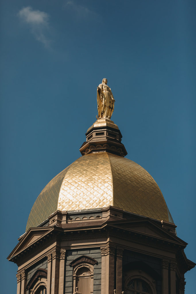 The Golden Dome at the University of Notre Dame close up shot against a deep blue sky