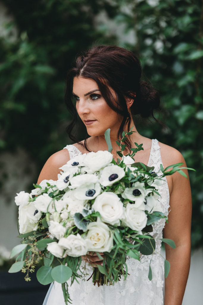 photo of bride holding bouquet and looking fierce before her Carmel backyard wedding