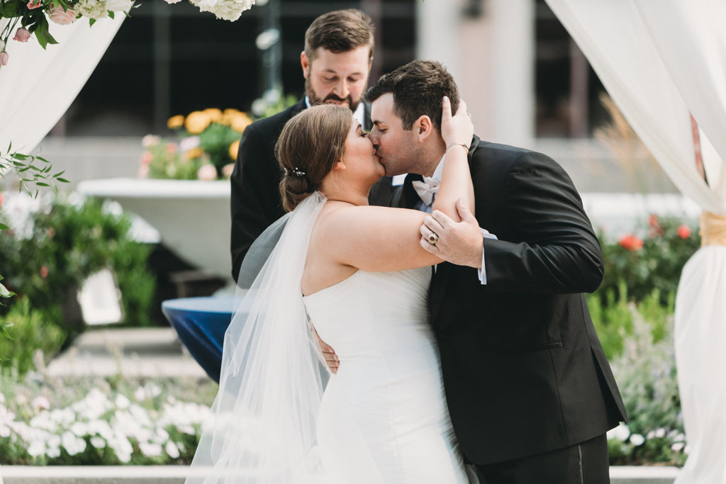 bride and groom share first kiss at their Charming Regions Tower Wedding
