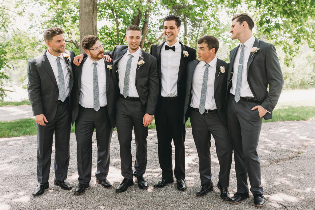 groom and groomsmen in front of St. Mary's Lake before a University of Notre Dame wedding