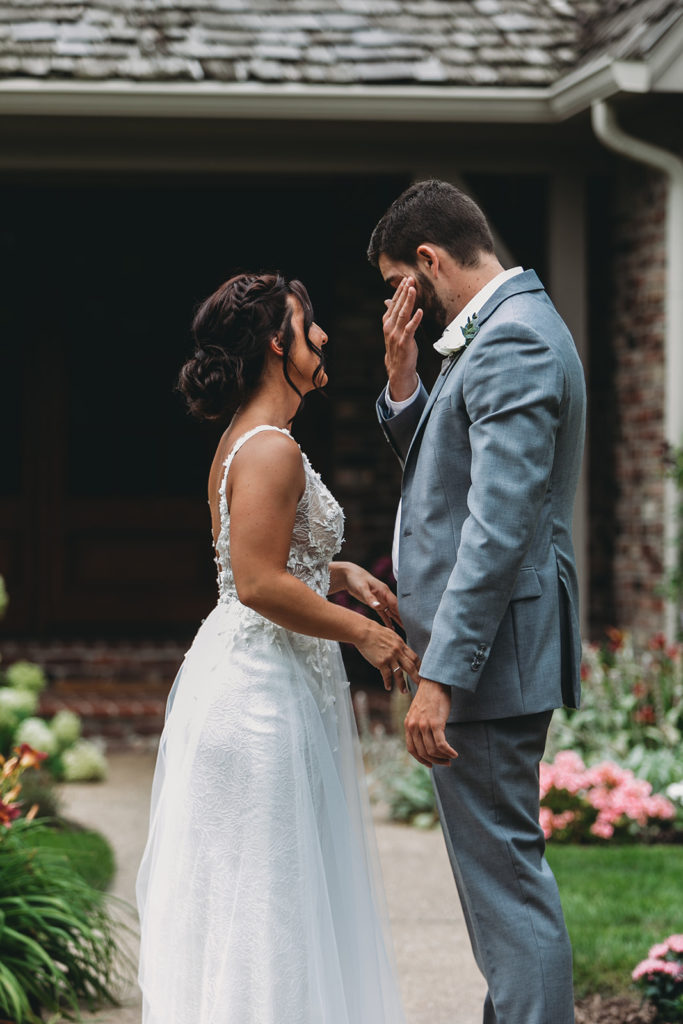 groom tears up during first look at his Carmel backyard wedding