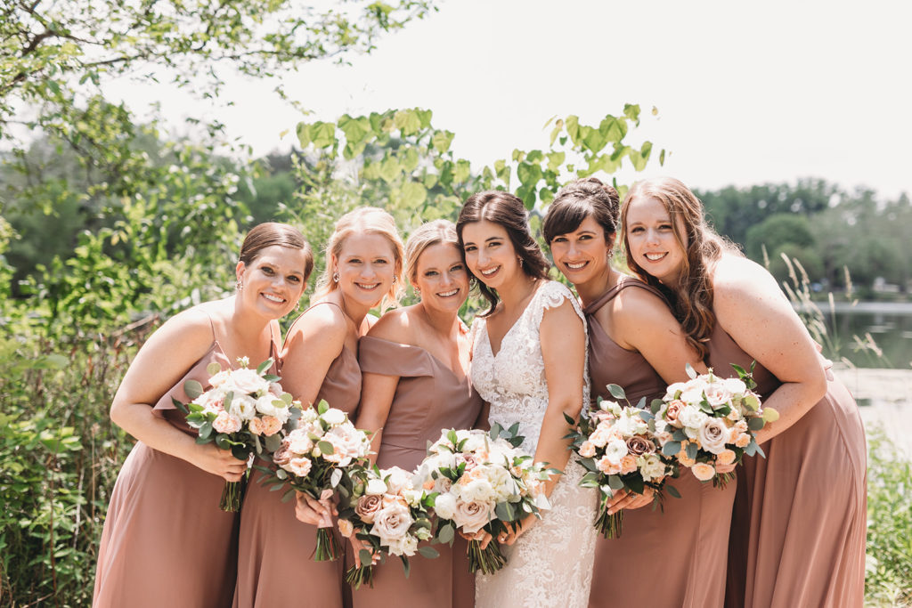 bride and bridesmaids in front of St. Mary's Lake before a University of Notre Dame wedding