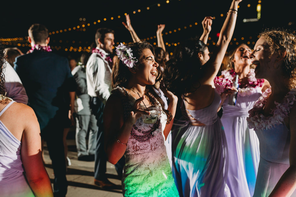 bride dances in rainbow light at her Indianapolis Hawaiian Jewish Wedding