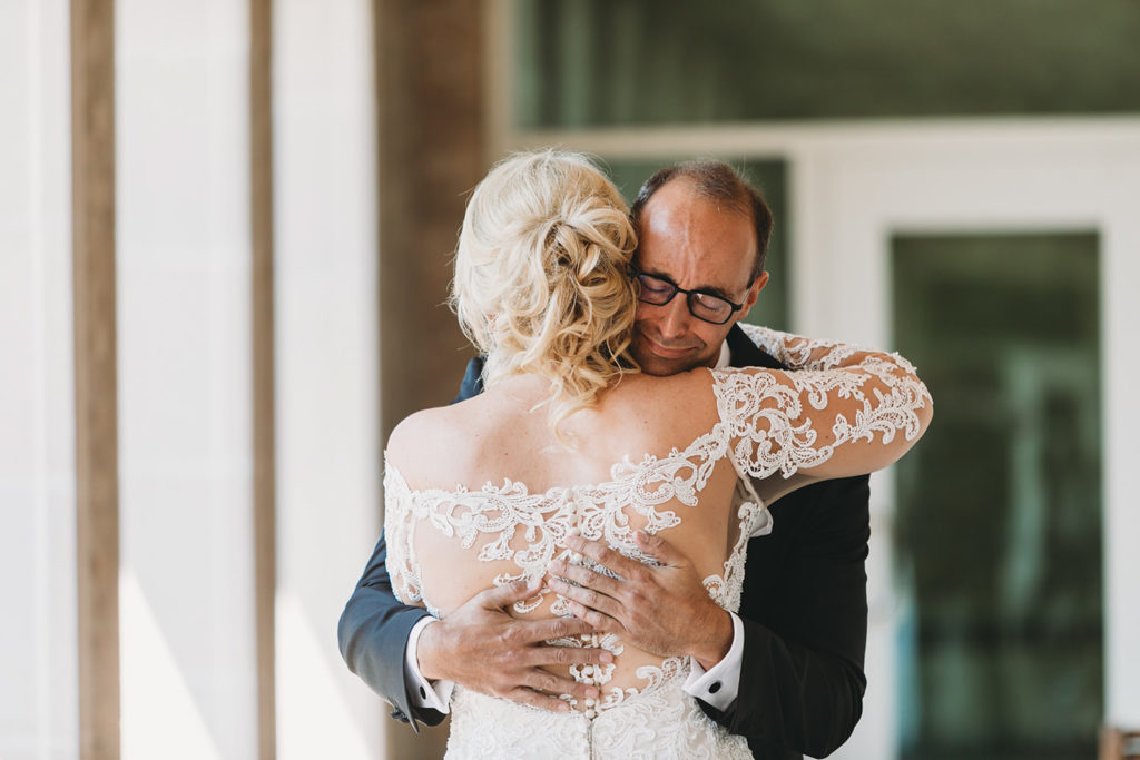 bride and groom hug after first look at their sand creek wedding