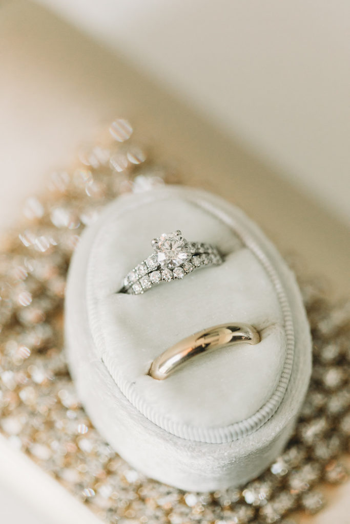 wedding rings and engagement ring in case before a sand creek wedding