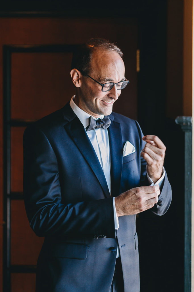 groom gets ready for his sand creek wedding