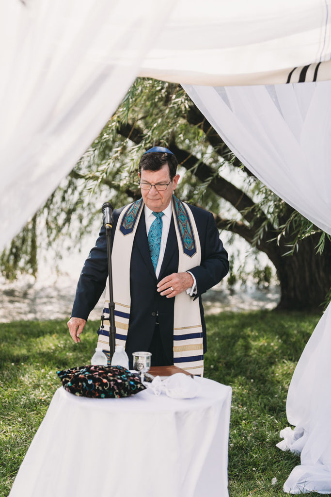 rabbi under chuppah at a charming coxhall gardens wedding