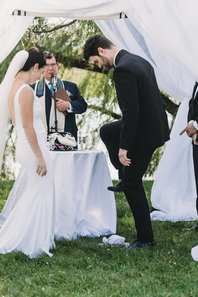 groom prepares to stomp glass at a charming coxhall gardens wedding