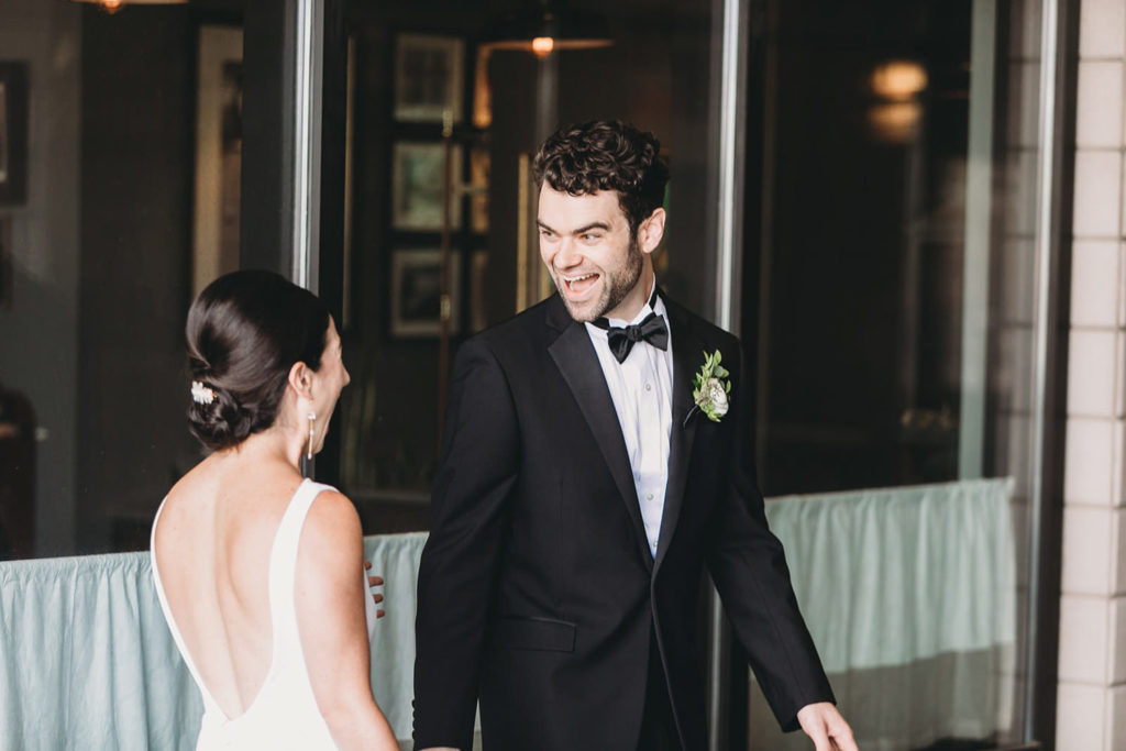 groom sees bride for first time on wedding day