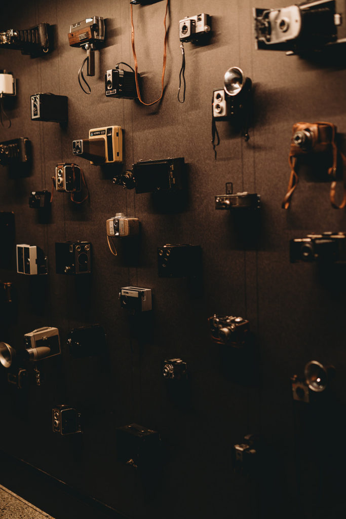 antique cameras mounted on a wall at the Bottleworks Hotel