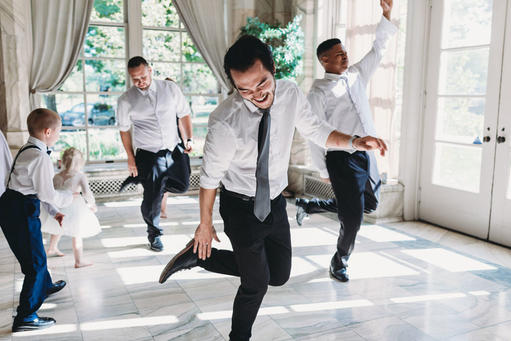 men dancing a jig during a marian university wedding