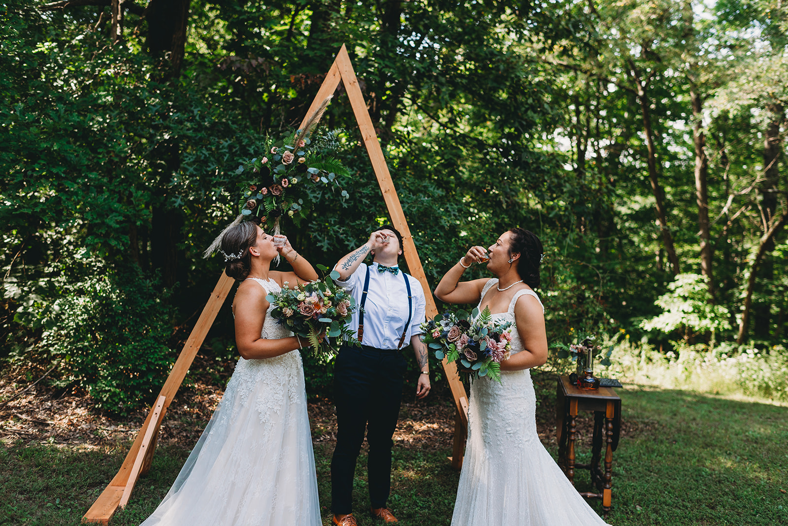 two brides take a shot with their officiant during their martinsville wedding ceremony