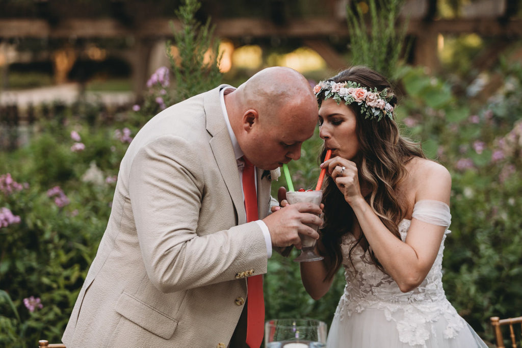 bride and groom share a shake instead of cutting cake during their Minnetrista wedding