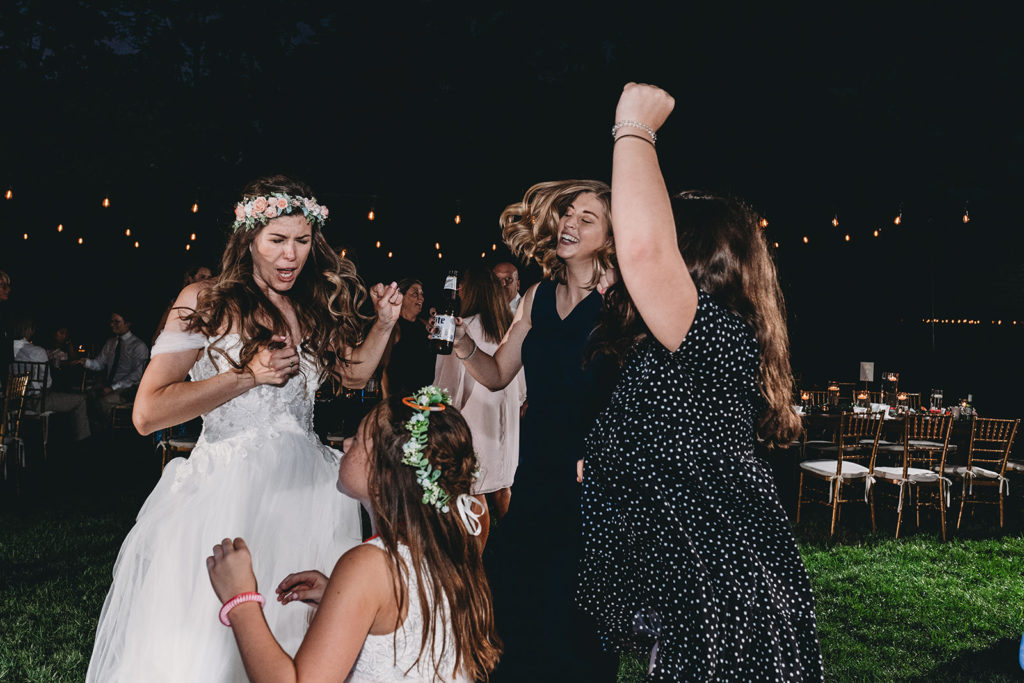 bride dancing with children at night during her Minnetrista wedding