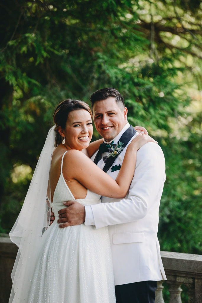 bride and groom hugging and smiling during a Newfields Lilly Terrace wedding