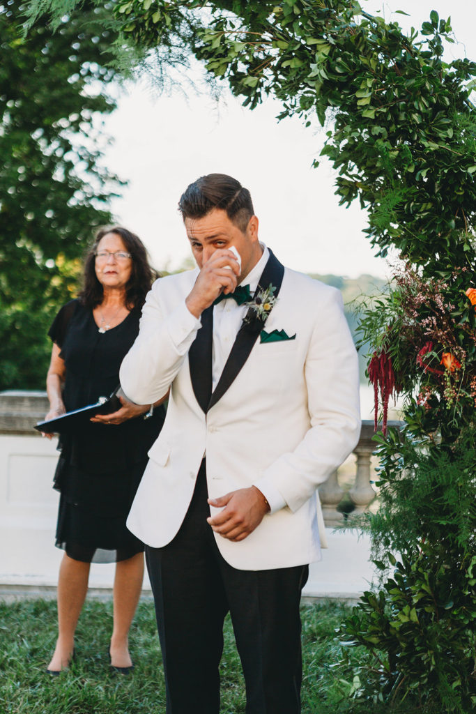 groom cries as bride walks down aisle during a Newfields Lilly Terrace wedding