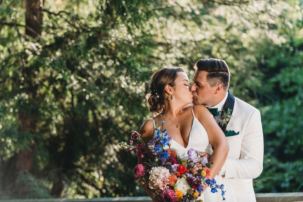 bride and groom kiss whilst backlit by sun during a Newfields Lilly Terrace wedding