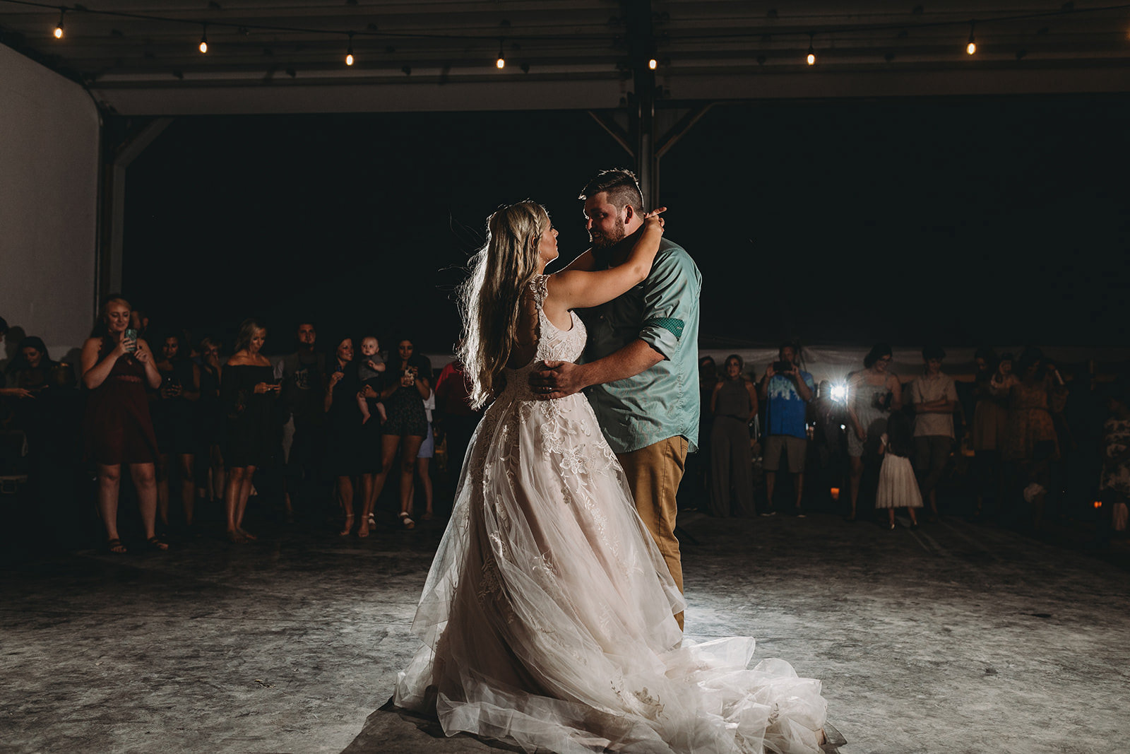 man and woman dance at night for their first dance at their Richmond Indiana wedding.