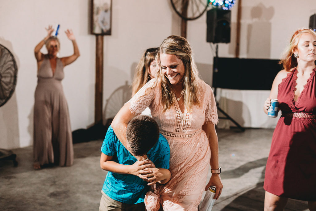 a mom hugs her son and smiles during a Richmond Indiana Wedding
