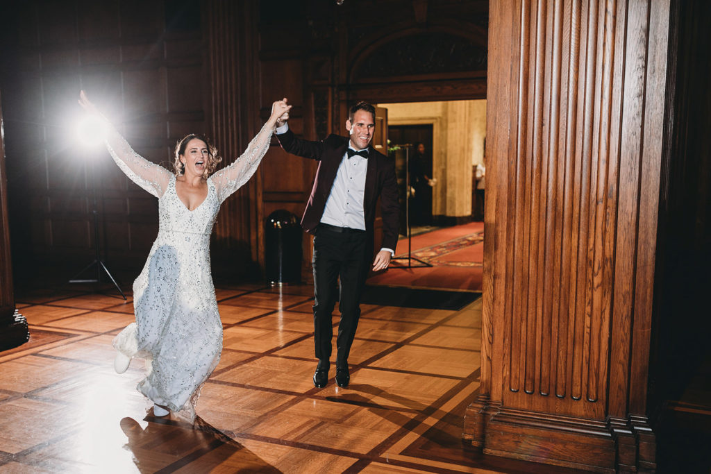 bride and groom enter reception space during a scottish rite cathedral wedding