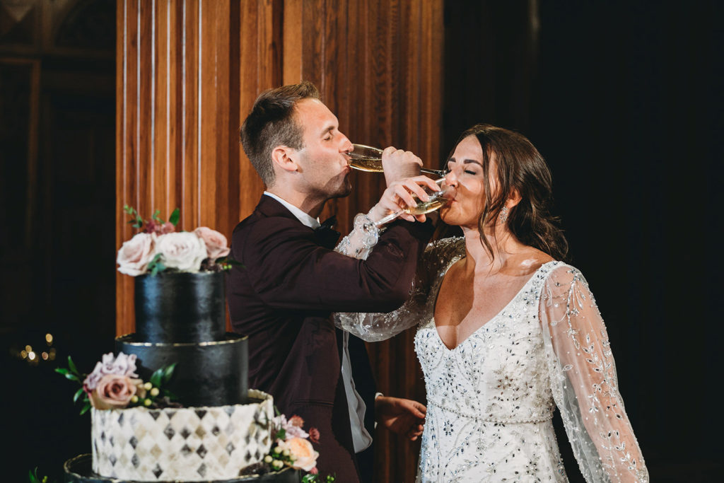 bride and groom drink champagne during a scottish rite cathedral wedding