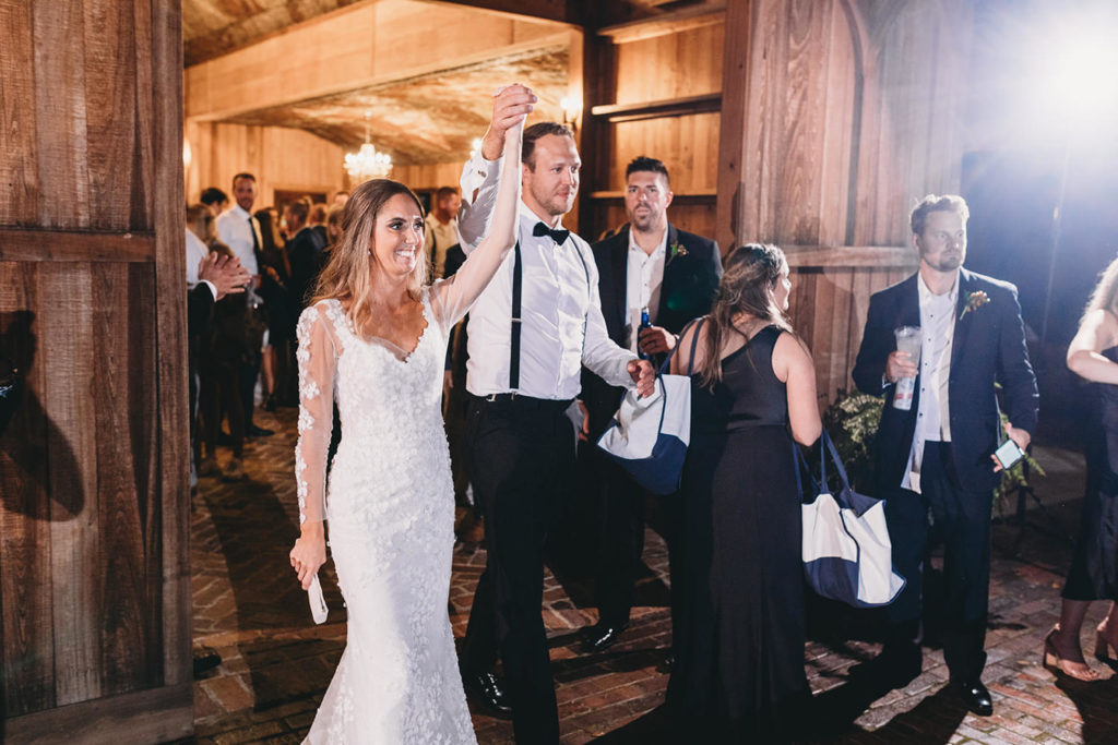 bride and groom leave reception hand in hand during their Artisan Acres Estate wedding