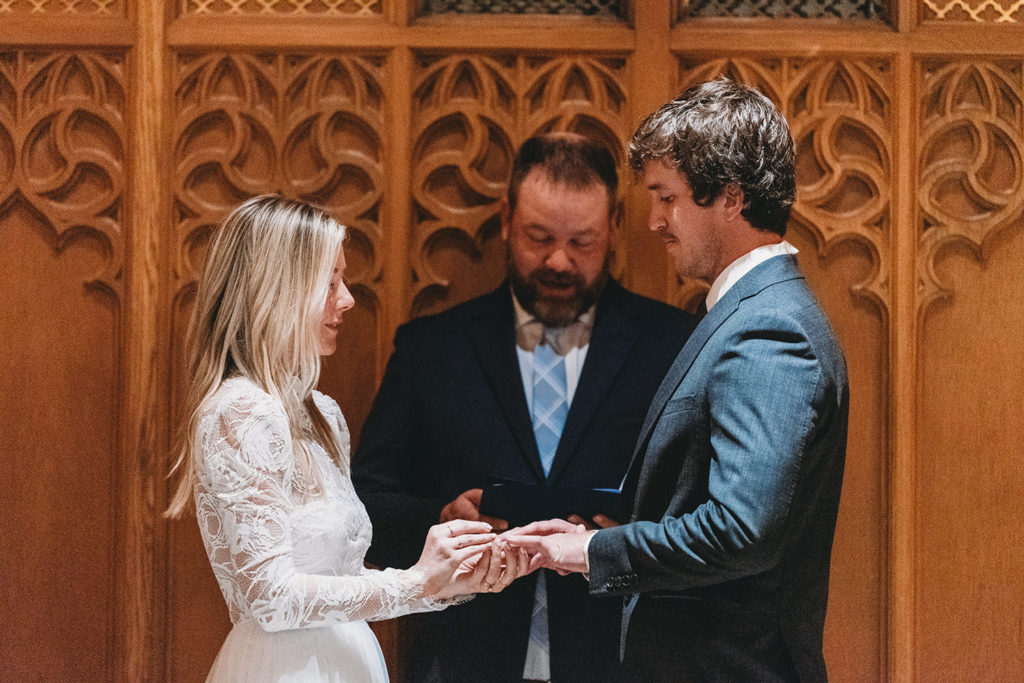 bride and groom exchange rings at beck chapel during their indiana university wedding