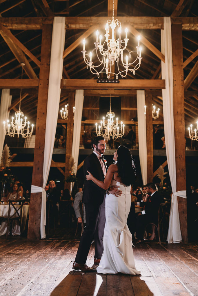 bride and groom first dance in barn during their mustard seed wedding