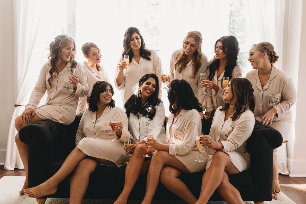 bride with bridesmaids in robes during their mustard seed wedding