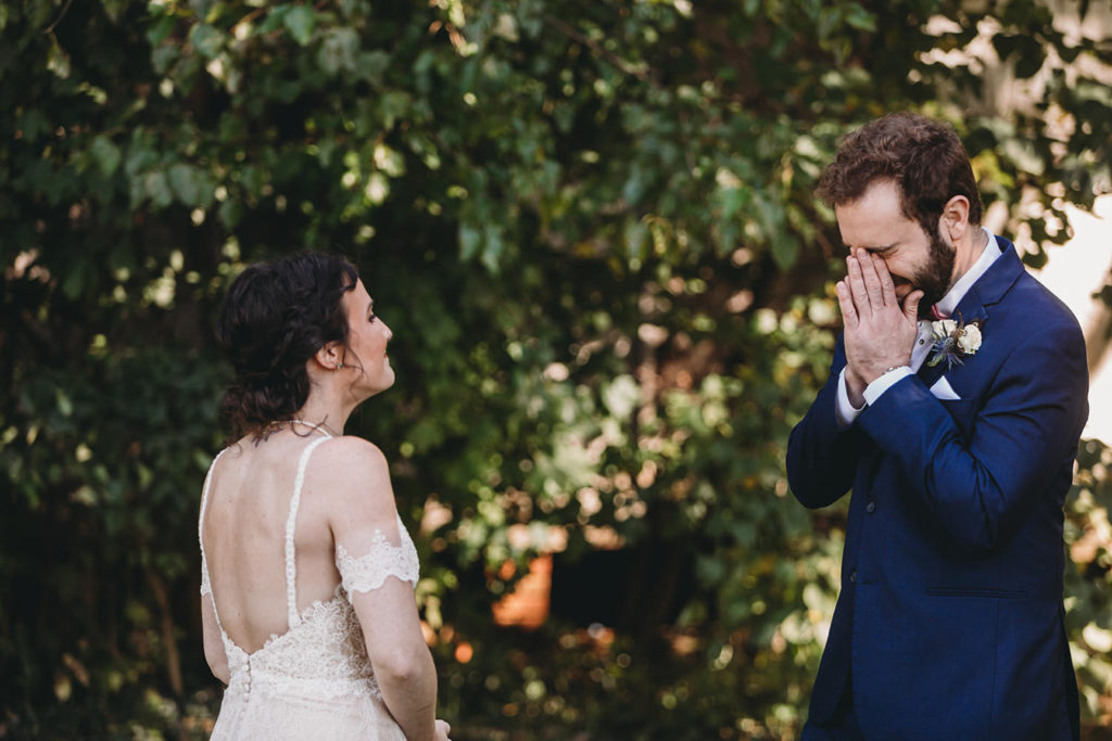groom cries as he sees bride for first time during their charming Lindley Farmstead wedding