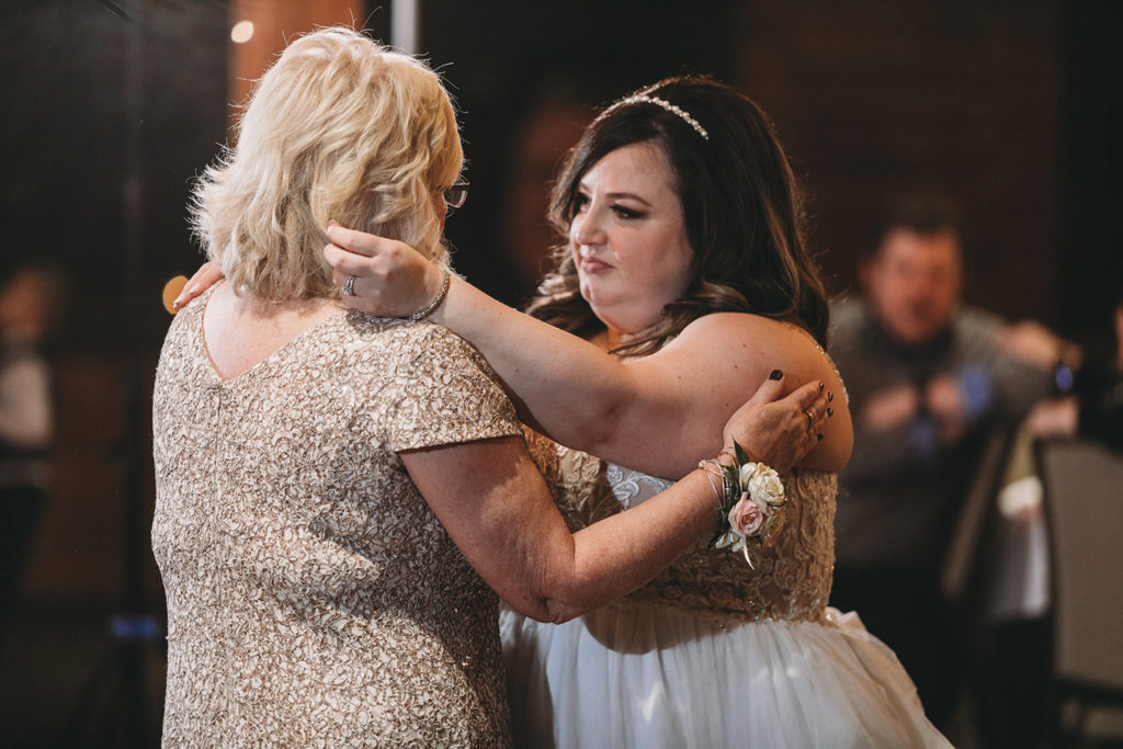bride dances with mom during their garment factory events wedding
