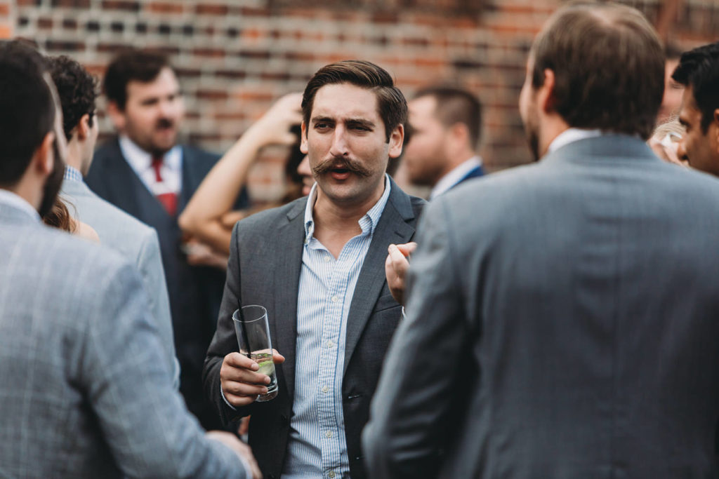 man with big mustache talking during their mavris reception