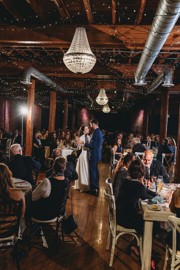 wide vertical shot of bride and groom dancing during their mavris reception