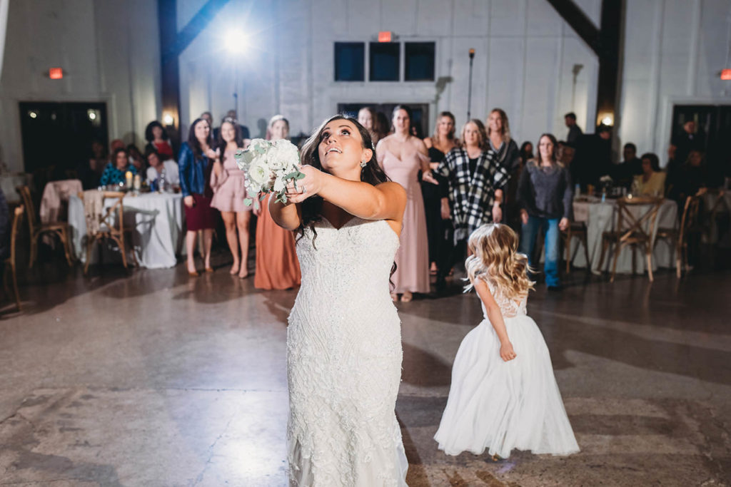 bride tosses bouquet during their white willow farms wedding