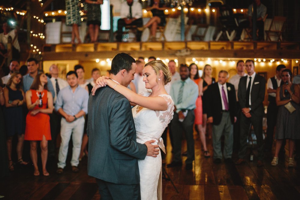 bride and groom dance in front of all their friends and family watching them from two different stories at morgan acres barn, one of the Best Indianapolis Barn Venues