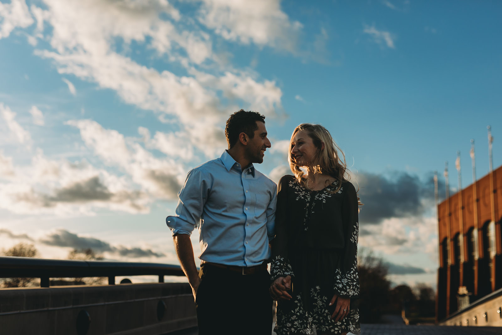 couple looking at each other at sunset and smiling during their wonderful white river engagement