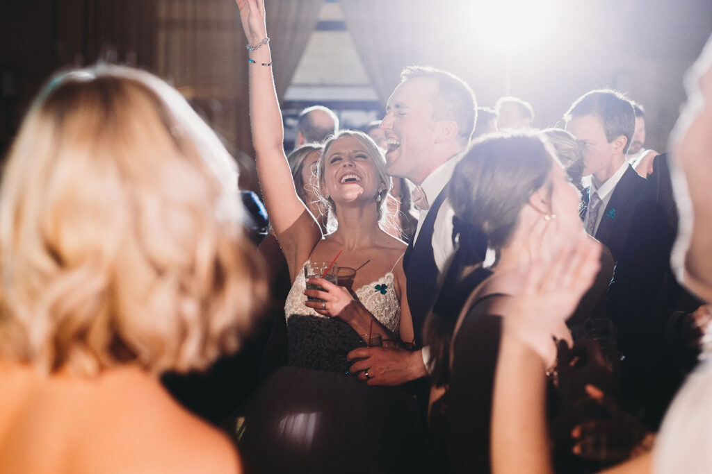 bride and groom singing on the dance floor with their guests for a Union Station Indy Wedding