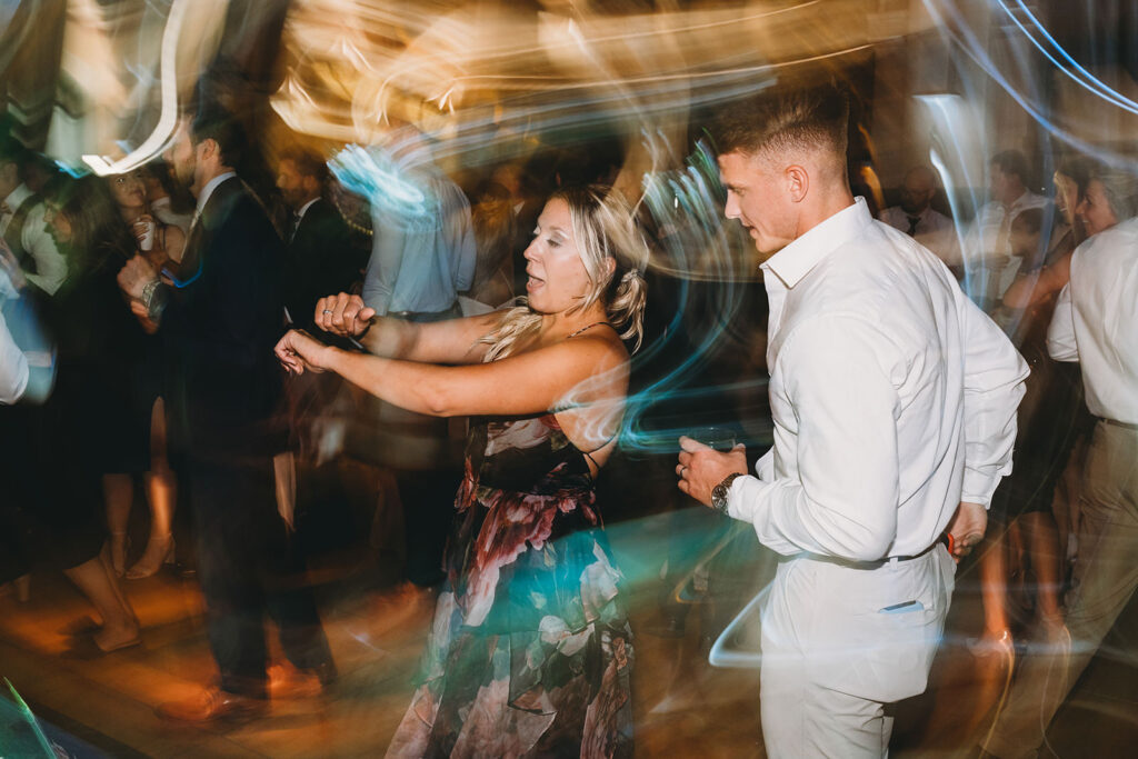 long exposure of people dancing with lights swirling around them for a Union Station Indy Wedding