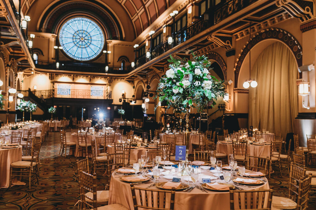 Wedding venue set up for wedding with tables and chairs and floral arrangements for a Union Station Indy Wedding