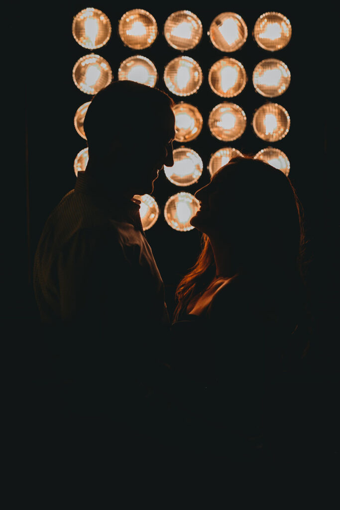 man and woman hug in silhouette during their le meridien engagement photo session